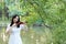 Young woman Dedicated playing violin ,Silhouette of teenage violin player over sunset on river,lake