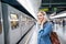 Young woman in denim shirt at the underground platform, waiting