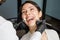 A young woman in a dental clinic with a dentist. The woman with braces smiles. The concept of healthy teeth.