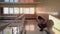 Young woman desperate to sit down on a wall in an empty corridor.