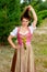 Young woman in dirndl playing with her hair and making grimace