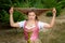 Young woman in dirndl playing with her hair and making grimace