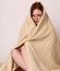 Young woman disaster survivor wrapped in a blanket