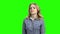 Young woman with distrustful look on green screen.