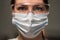 Young woman doctor or nurse working. Girl in medical mask, glasses.