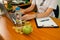 Young woman doctor sitting at the desk with eco food.