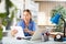 Young woman doctor studies the patient's outpatient card while sitting at a computer in the office