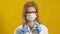 Young woman doctor. Yellow background. The concept of medicine.