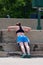 Young Woman Does Pushups Against Concrete Steps