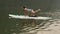 Young woman does yoga on paddleboard