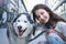 Young woman with dog In city. Teenager girl poses with her dog.