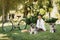 Young woman with dogs and bicycle having picnic in the park