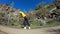 Young woman doing acrobatic flip with landscape on background