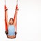 Young woman doing anti-gravity aerial yoga in