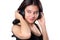 Young woman doing a bWoman listening to music on headphones enjoying a musicicep curl isolated on whit