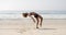 Young Woman Doing Cartwheel On The Beach