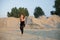 young woman doing eagle yoga pose outdoors