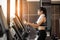 Young woman doing exercise cardio on elliptical trainer at gym