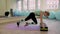 Young woman doing fitness indoors, doing stretching. girl shakes the press. healthy lifestyle and sports. the camera moves