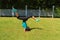 Young woman doing handstands at the park in summer