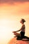 Young Woman doing Lotus Yoga Position in Front of the Ocean