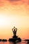 Young Woman doing Lotus Yoga Position in Front of the Ocean