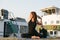 young woman doing pigeon yoga pose at the river bank