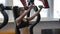 Young woman doing seated chest press on machine in modern gym indoor.