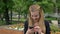 young woman doing selfie on summer day in park. Smiling girl making selfie