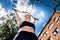 Young woman doing sports on the horizontal bar. Woman pull-ups herself up on bar on sports ground. Girl on street workout