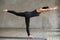 Young woman doing Virabhadrasana 3 exercise