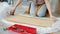 Young woman doing woodwork using tools making shelf during relocation