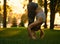 Young woman is doing yoga asana Uttanasana - Standing Forward Fold in the park at sunset