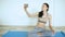 Young woman doing yoga exercise making selfie smile in smartphone