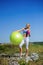 Young woman doing yoga exercises on the ball