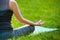 Young woman doing yoga exercises in the summer city park.