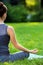 Young woman doing yoga exercises in the summer city park.