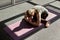 A young woman is doing yoga in the gym. A girl meditates against the background of panoramic Windows in a modern yoga Studio. Type