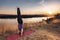 Young woman doing yoga head stand at sunset