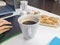 A young woman drank a glass of coffee accompanied by snacks during breaks during work time