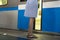 Young woman in a dress standing on peron next to train passing by
