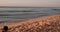 Young Woman Dressed Swimsuit and Hat Lying on the Sandy Sea Beach, Having Picnic with Fruits at Sunrise Dawn and Working