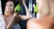 Young woman dries hair with electric hair dryer closeup