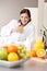 Young woman drink orange juice in kitchen