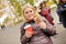 Young woman drinking coffe with ginger gingerbread in autumn time in park