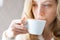 Young woman drinking coffee. Cup of hot beverage