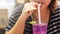 Young woman drinking cold purple cocktails refreshing water, food and drink for summer season