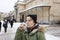 Young woman drinking from cup with therapeutic mineral water at a natural hot spring in Karlovy Vary during winter time