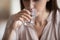 Young woman drinking glass of fresh still pure water.