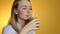 Young woman drinking green vegetable smoothie